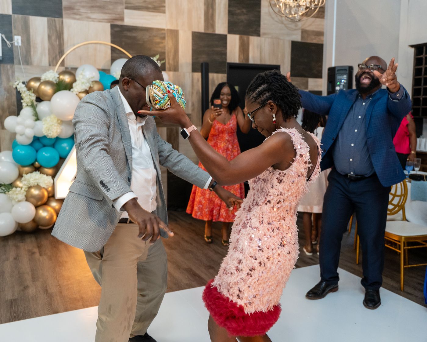 Hilda dancing at her surprise 40th birthday while friends cheer