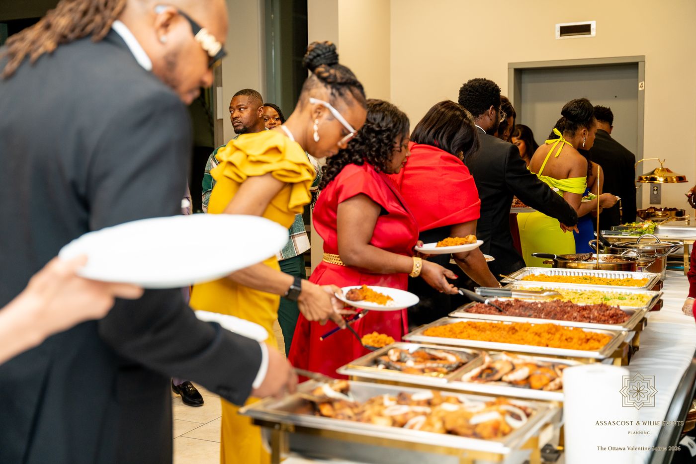 Guests in evening wear serve themselves at the buffet