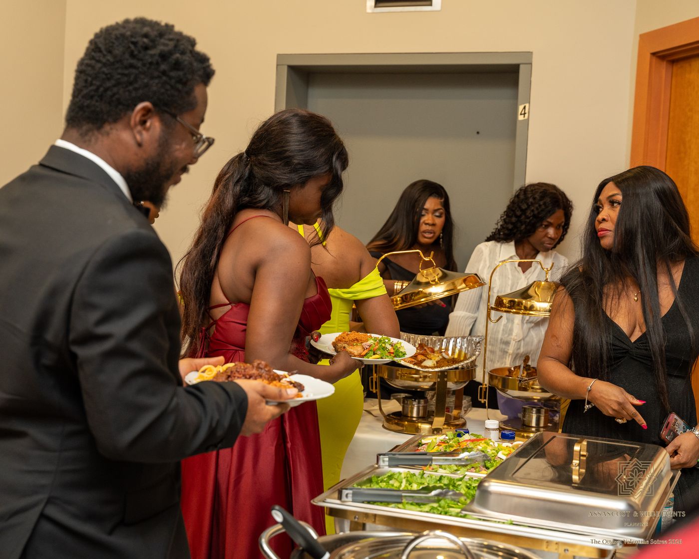 Guests filling their plates at the buffet