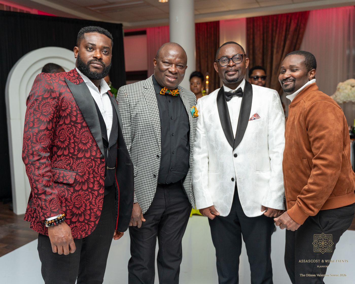 Four guests posing together in patterned jackets